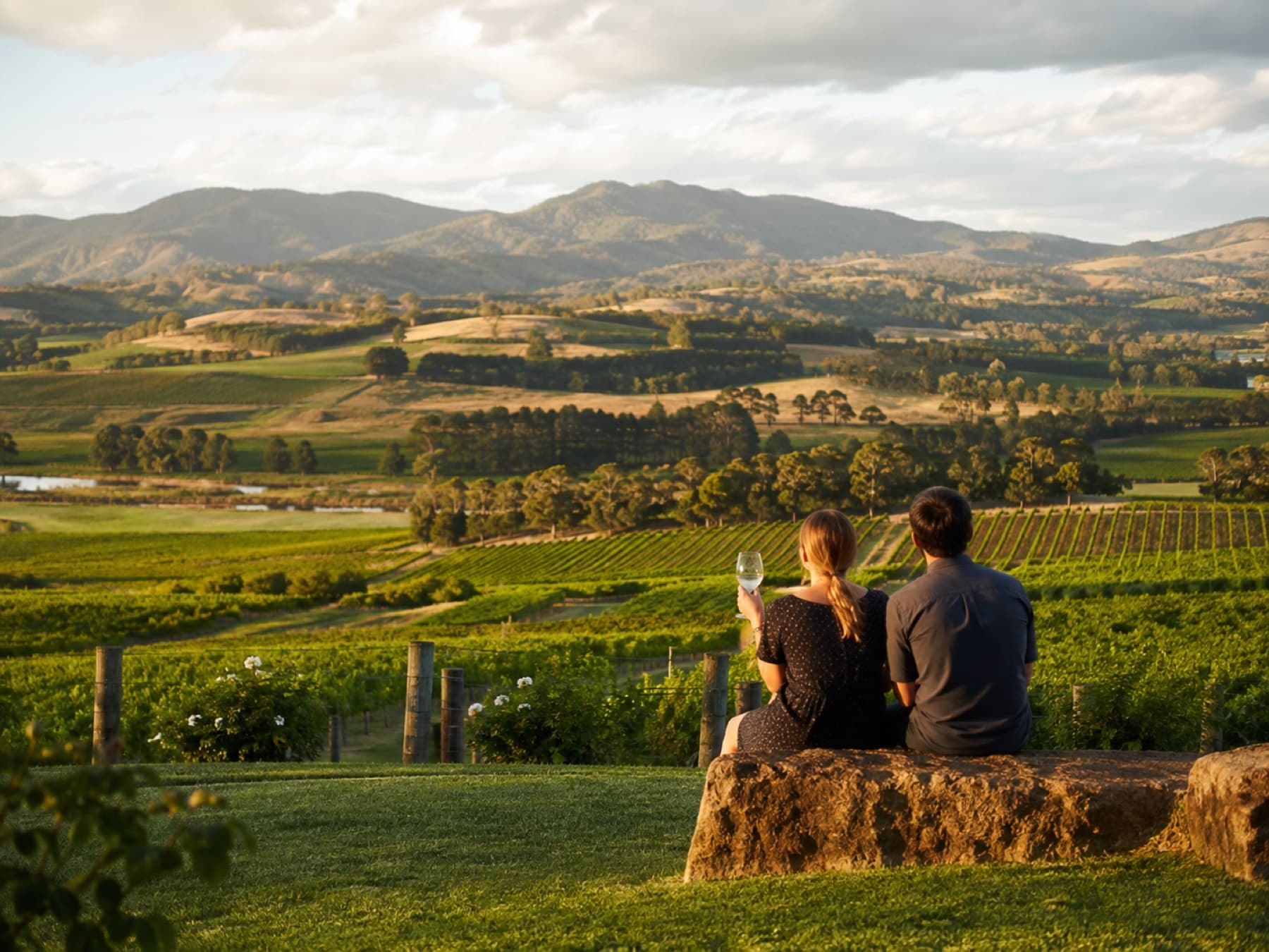 A couple looking over Yarra Valley vineyards at dusk